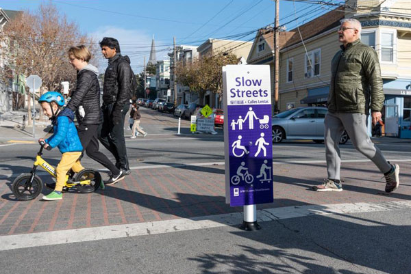 Example of a successful slow street with people walking and biking